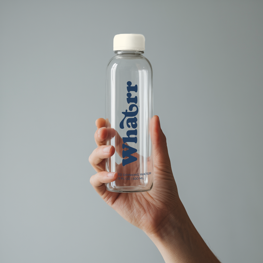 Hand Holding Biodegradable Whatrr Bottle with Spring Water 